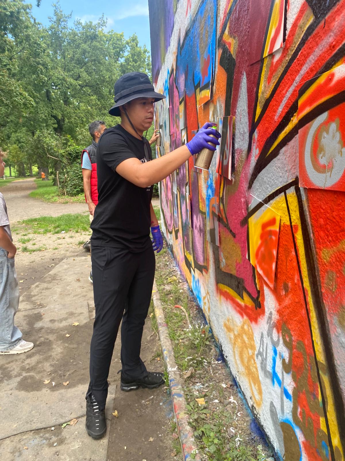 Urban-Art-Workshop für Schulen – Schüler sprühen aktiv an einer Wand